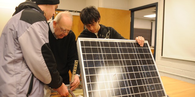 Physics students work with Dr. Nelson Kilmer on a solar energy project.