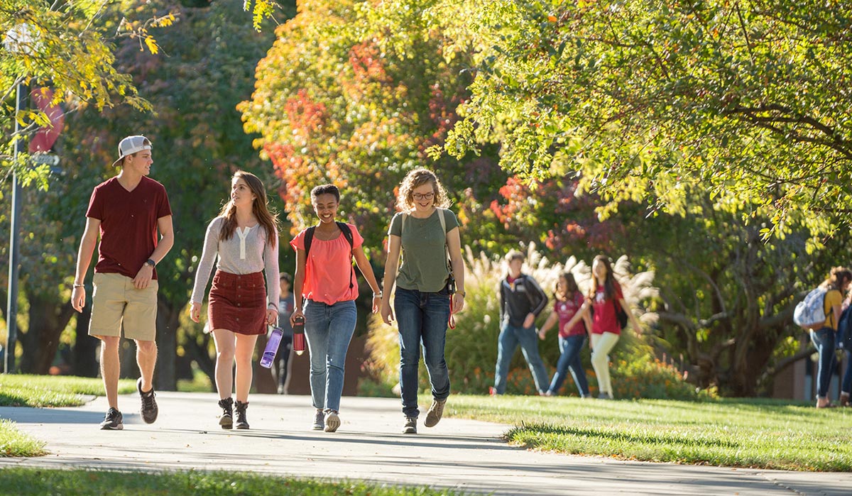 Four students walking on the Hesston College campus