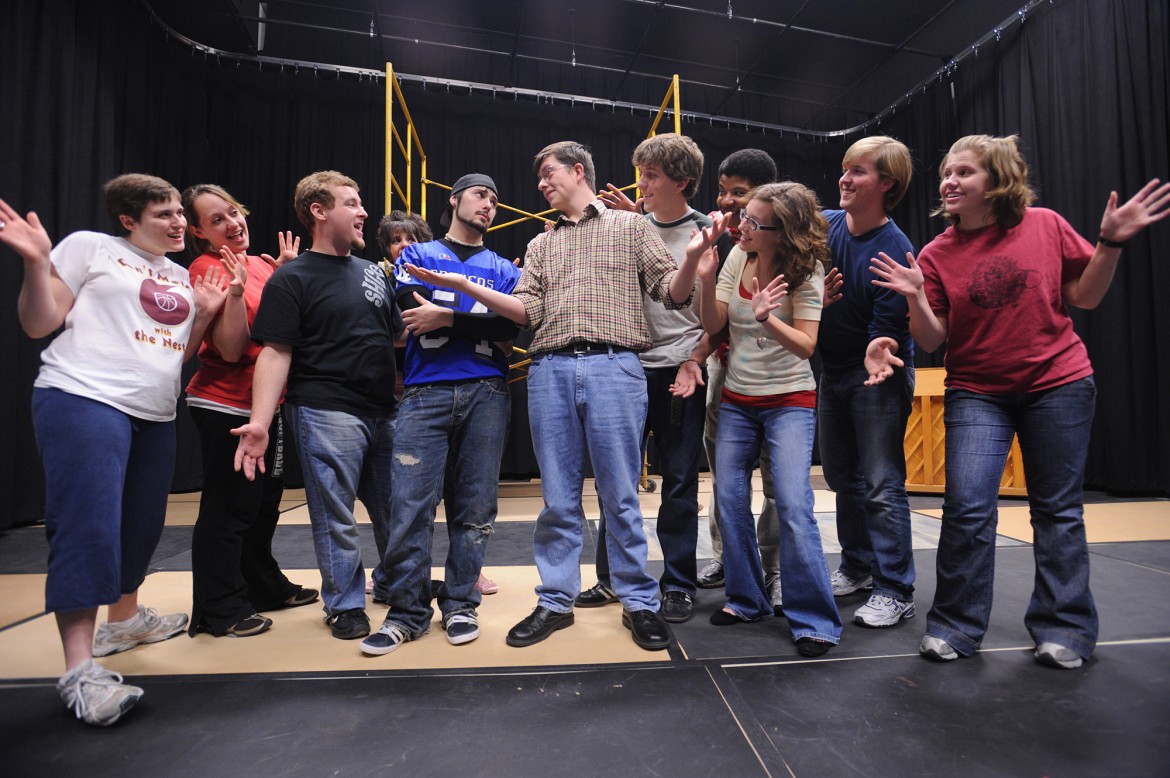 Cast members rehearse a scene in the Hesston College production of Godspell. Pictured (left to right) are: Hannah Titus, Tessa Walters, John N. Murray, Kaitlyn Schmucker, Carson Stutzman, Mitch Stutzman, Matt Lehman, Peter Garry, Lauren Zehr, Nathan Snyder, and Ana Loucks.