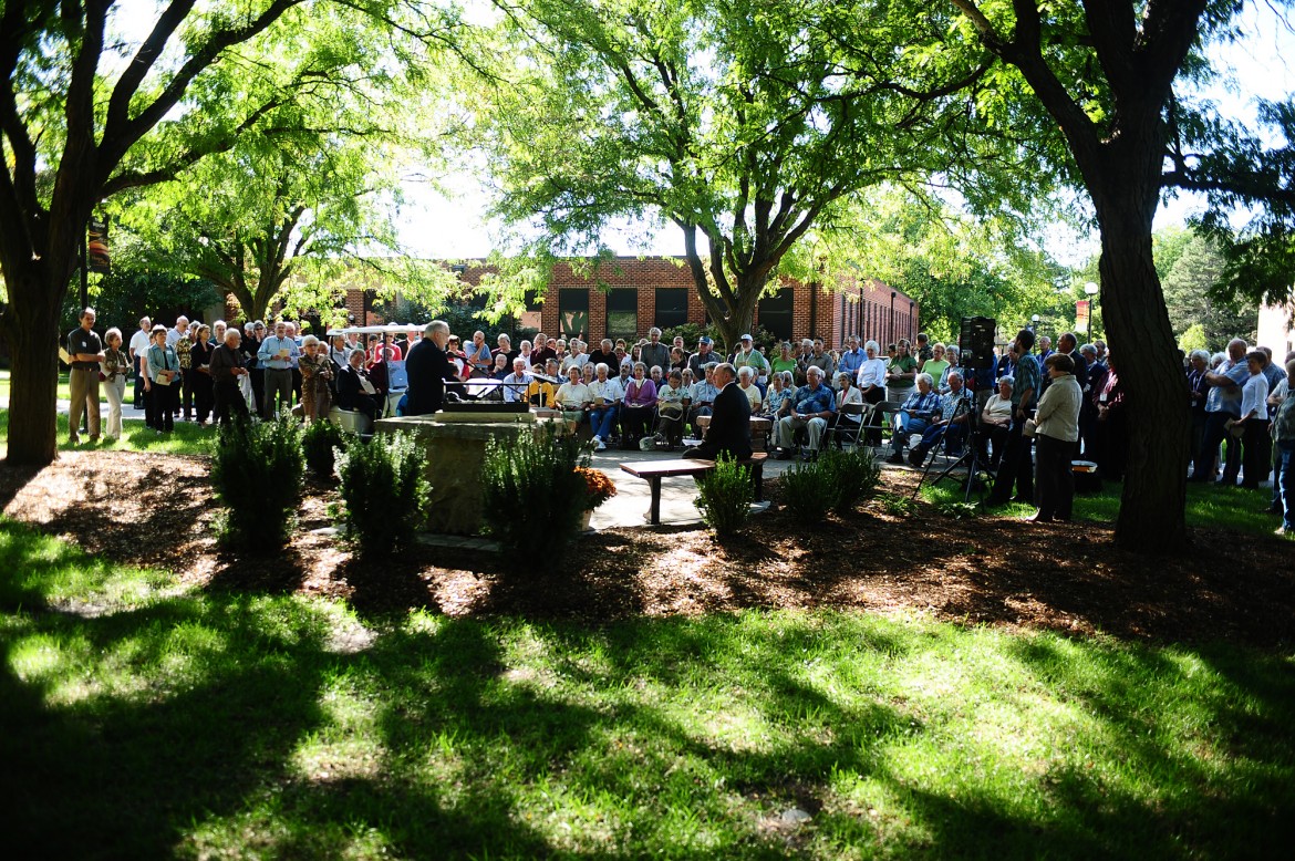 A crowd gathers to dedicate the Freedley Schrock memorial at Hesston College.