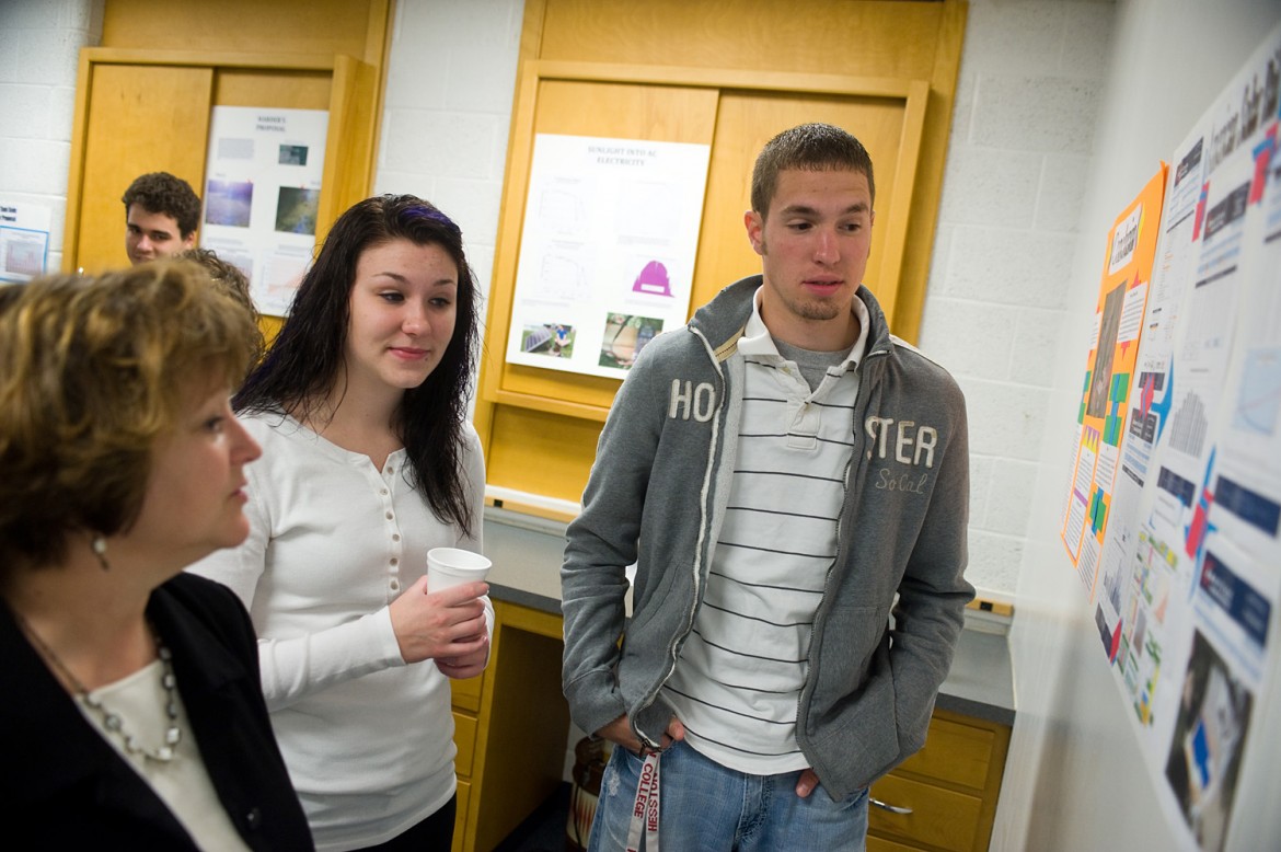 Hesston College sophomores Breezie Sims and Kyle Vogt share the results of their research with vice president of Advancemenet Yvonne Sieber at an Earth Day celebration.