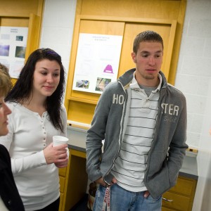 Hesston College sophomores Breezie Sims and Kyle Vogt share the results of their research with vice president of Advancemenet Yvonne Sieber at an Earth Day celebration.