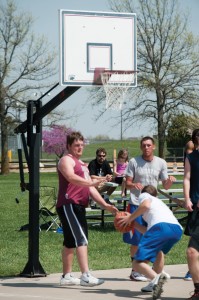 Hesston College Business faculty member David LeVan watches a three-on-three basketball tournament.