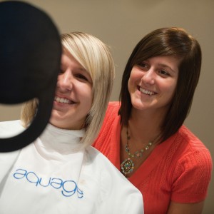 Sarah Lederman (right) checks her work after cutting sophomore Kalen Boshart’s (Wayland, Iowa) hair at Studio 400 in Hesston.