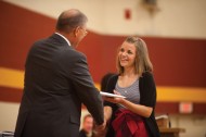 Kayci Detweiler of Kokomo, Ind., receives her Hesston College diploma from President Howard Keim at the college’s centennial commencement.