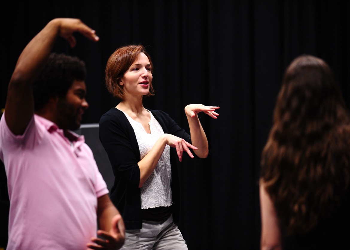 Hesston College theatre director Laura Kraybill performs an exercise with her students in acting class.