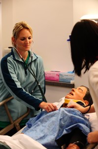 Hesston College nursing students work with a patient in the college’s nursing simulation lab