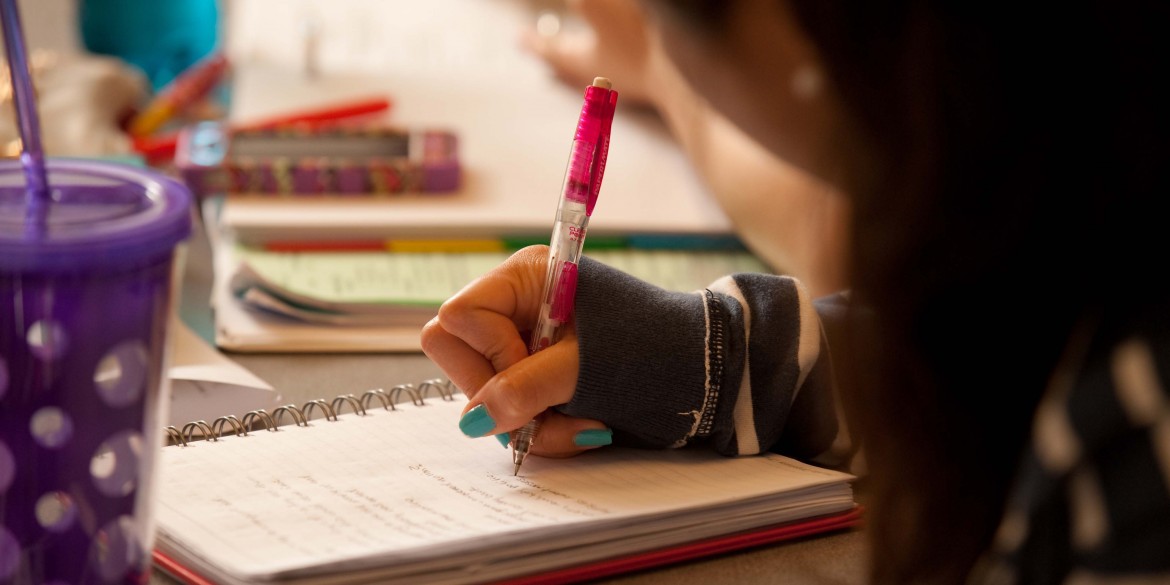 stock image of student taking notes