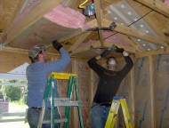 David Hochstetler (left) and John Schoenhals install insulation in a home in Picayune, Miss., during their fall break in 2009.