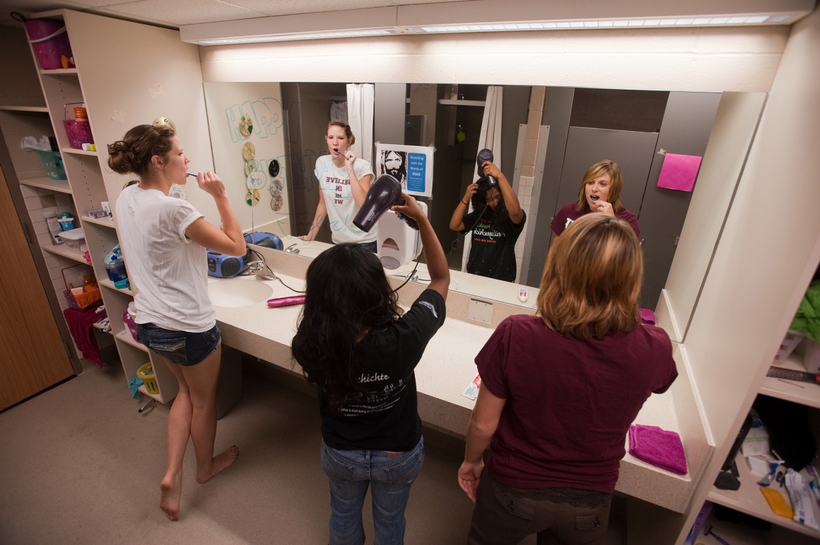 Hesston College students prepare for the day in a recently renovated bathroom in Erb Hall.