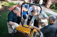 Brian Nebel ’83 (far right) explains the Zeon Electric Mower to symposium attendees. Nebel is director of Engineering at Excel Industries in Hesston.