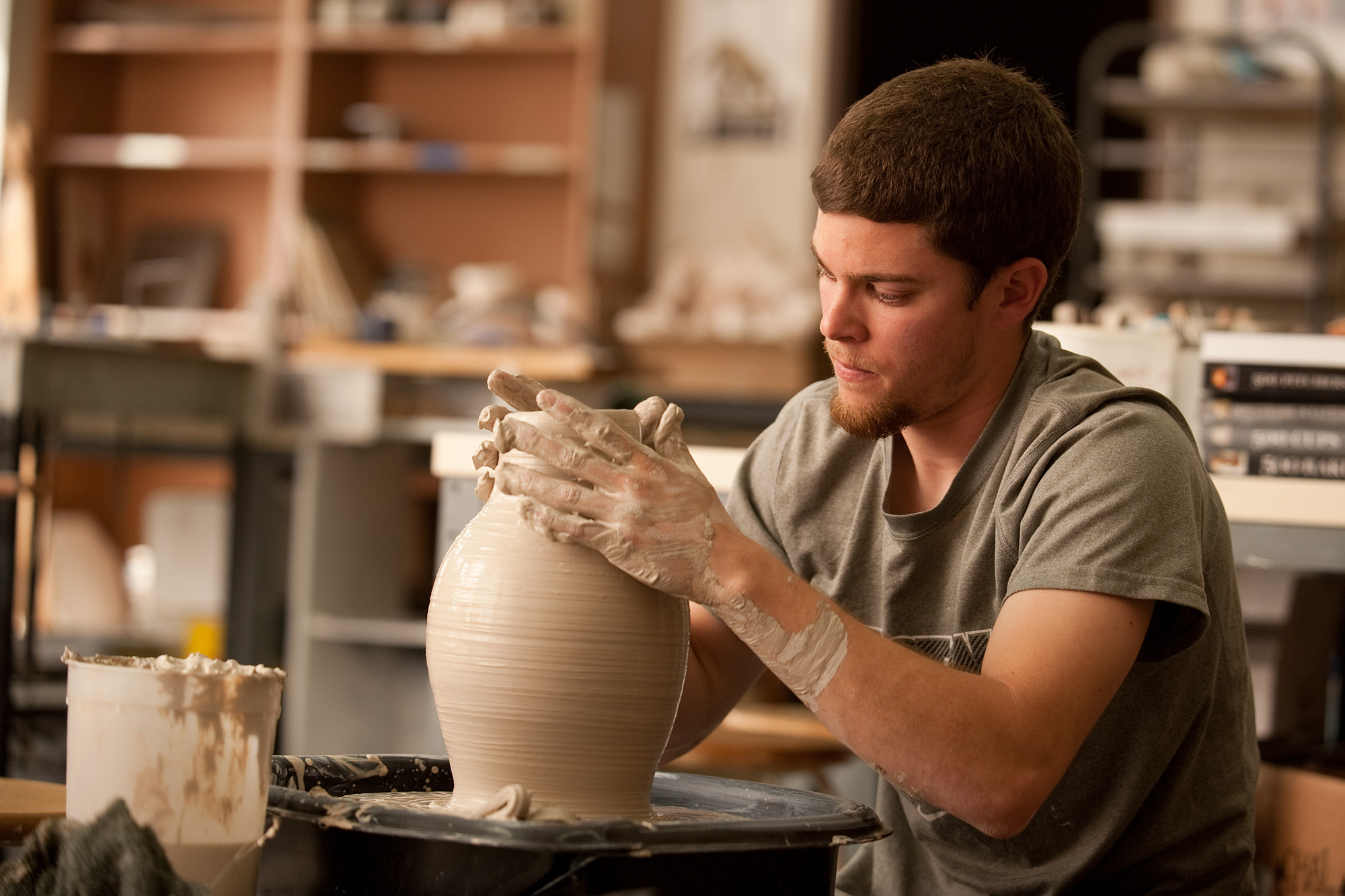 A student throws in the ceramics studio