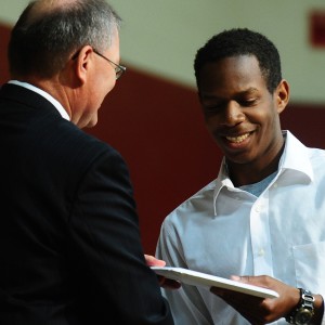 Curtis Denlinger of Perkasie, Pa., receives his Hesston College diploma from President Howard Keim. Denlinger was one of 139 students to receive a diploma.