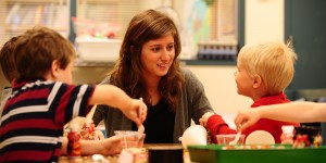  Deb Yoder works with preschoolers in the Hesston College Lab Preschool. The preschool serves as a learning environment for both preschool children and for the college students who work with them.