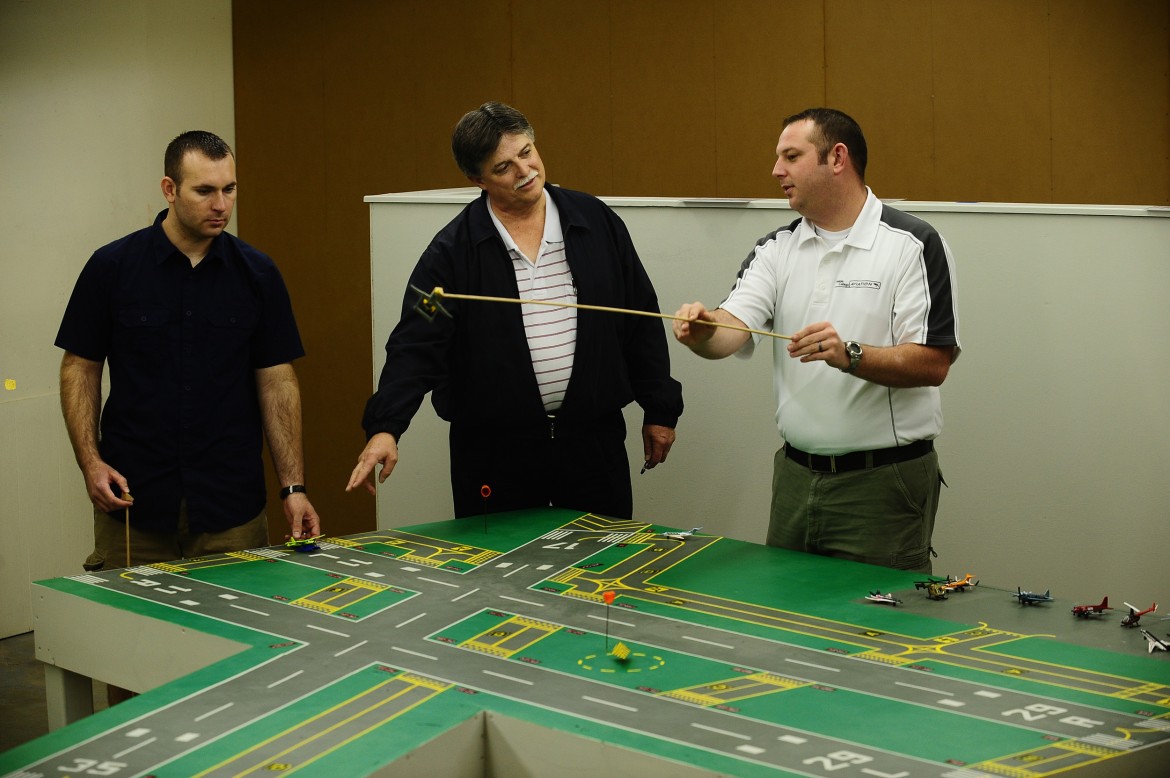 Hesston College faculty member Dan Miller works with air traffic control students in the ATC lab.