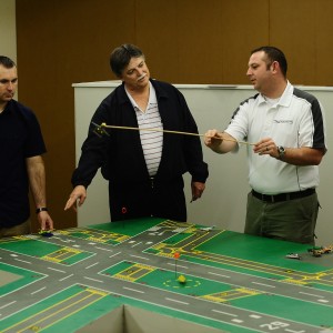 Hesston College faculty member Dan Miller works with air traffic control students in the ATC lab.