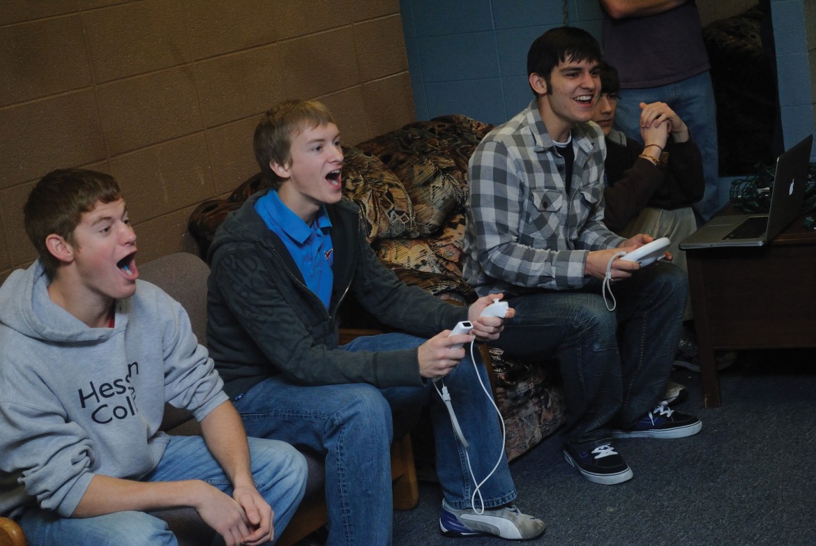 From left, freshman Kenny Graber of Stryker, Ohio, Bradley Sandlin of Valley Center, Kan., Stephen Quenzer of Visalia, Calif., and Harrison Beachey of New Paris, Ind., play a video game in their Erb west lounge.
