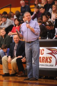 Former Hesston College women’s basketball coach Joel Kauffman addresses the crowd at Yost Center during the annual Pizza Hut Thanksgiving Basketball Classic.