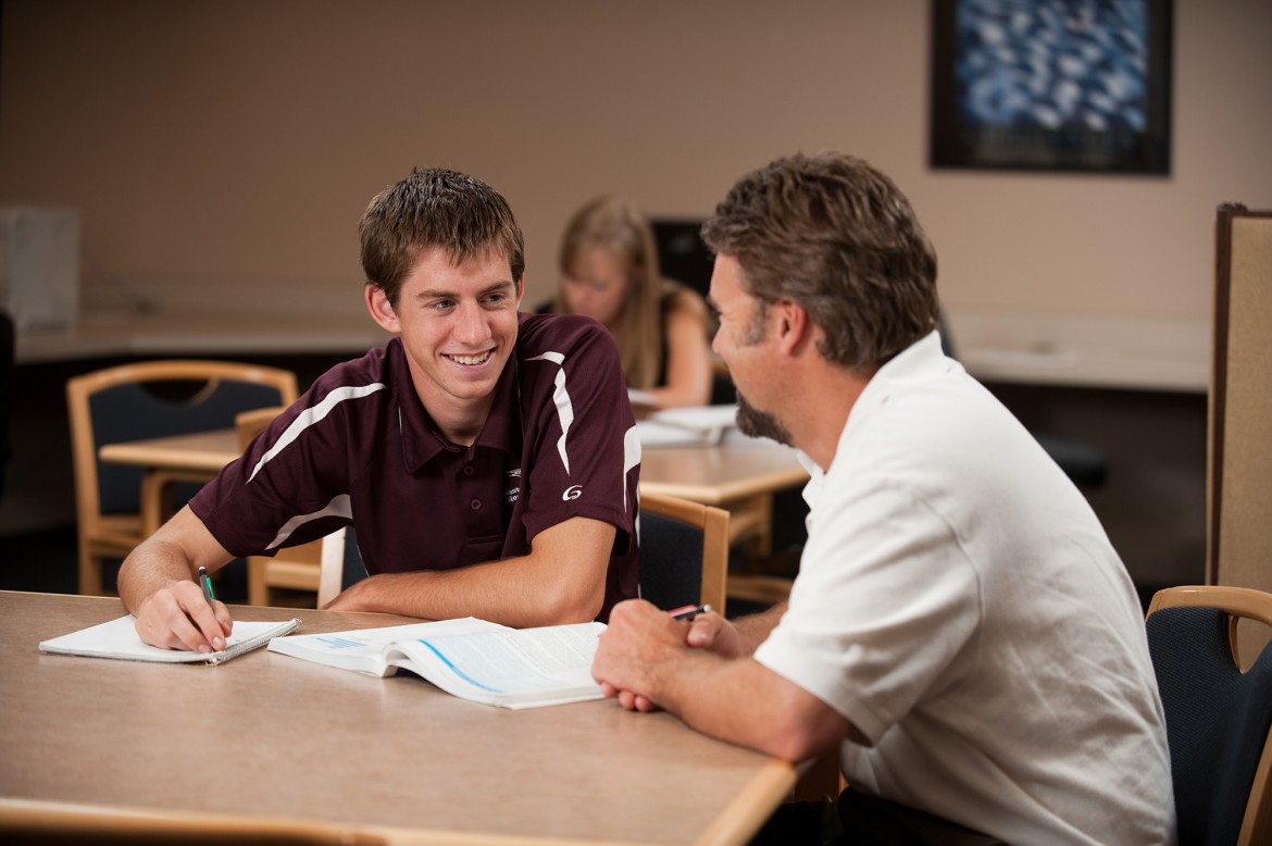 Elliot Wilder ’11, Hesston, Kan., gets help from business faculty David LeVan in the ACCESS lab.