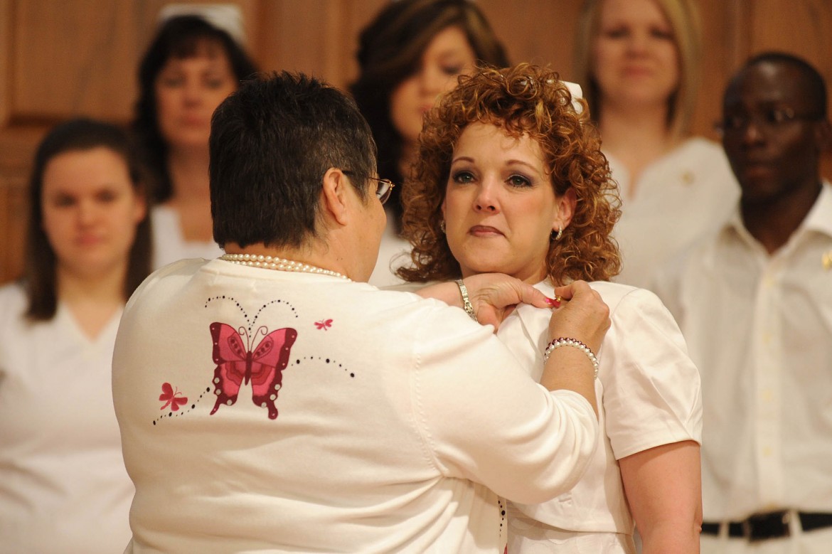 Lisa Harrelson receives her nursing pin from instructor Ruby Graber