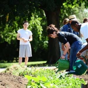 Dulaney Arzola of Stafford, Kan., and other students in the First Year Experience seminar work in the Intergenerational Community Garden.