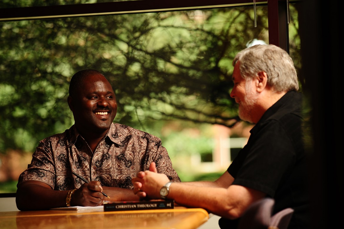 Ron Moyo discusses class concepts with Tim Lichti, Director of the Hesston College Pastoral Ministries program.