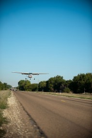 A Hesston College airplane, flown by instructor Travis Pickerill ’99, prepares to land north of town on Old Highway 81. The plane was displayed on campus over the weekend.