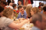 Ben Savanick ’97 talks to his wife, Angie (Book) ’98 Savanick, during the Partner Luncheon.