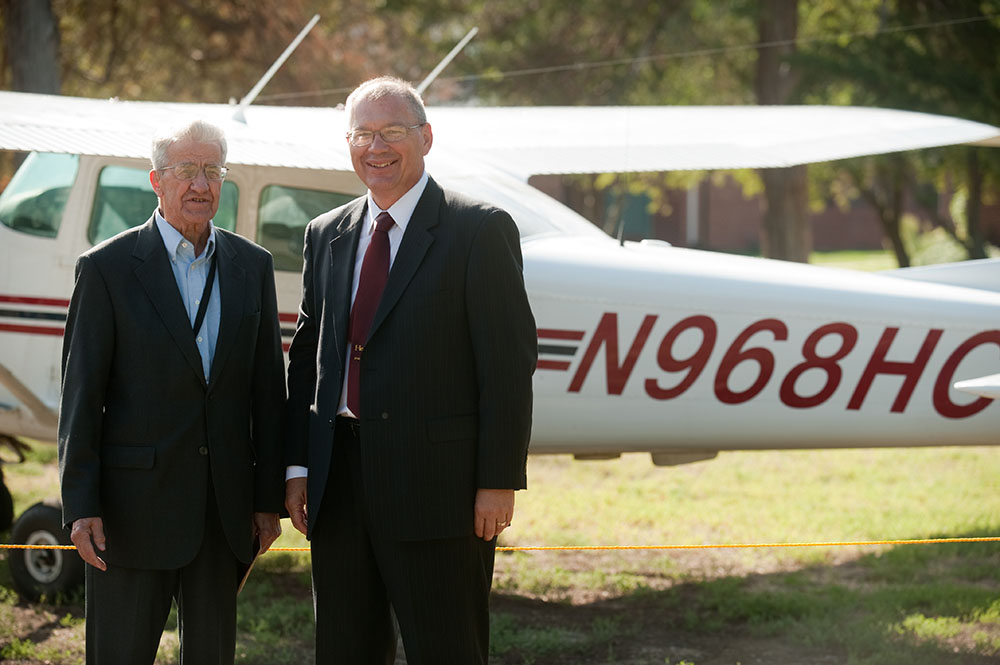 Former President Laban Peachey (1968 to 1980) and President Howard Keim pose with the Hesston College airplane with the radio call numbers in honor of President Peachey. Each of the college’s five planes’ call numbers includes the inauguration year of one of the presidents.