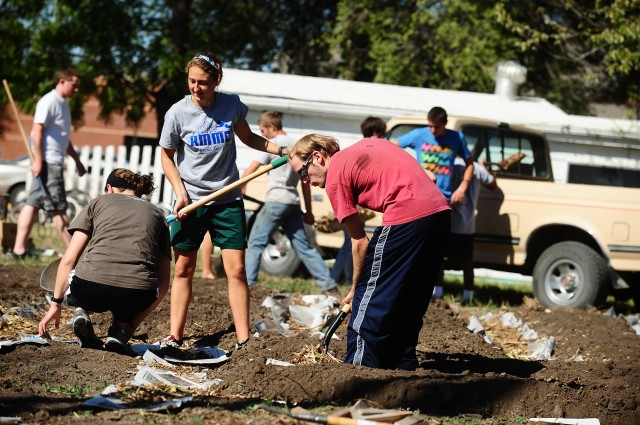 garden_1604 Sophomore Krista Rittenhouse (Mount Pleasant, Pa.) and Fritz Lehman (Dalton, Ohio) work in the community garden. Volunteers built raised beds for planting, created mulch paths and constructed compost bins.
