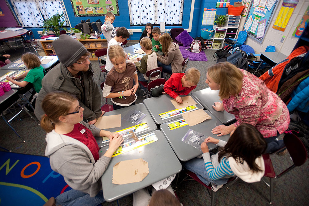 Hesston College Environmental Biology students work with Hesston Elementary third graders.