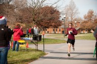 Freshman Jacob Landis (Sterling, Ill.), crosses the finish line during the 20th annual Howard Hustle Two-Mile Run/Walk. Landis, who is a member of the cross country team, finished the race as the top overall finisher and top male finisher with a time of 10:33.