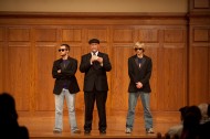 Joel "Bill" Murray (Hesston, Kan.), and Brad "Bill" Sandlin (Valley Center, Kan.), act as President Howard Keim's body guards as he introduces the next act at the talent show. Murray and Sandlin, are members of the student group "The Bills and Normas," who are known for their antics around campus.