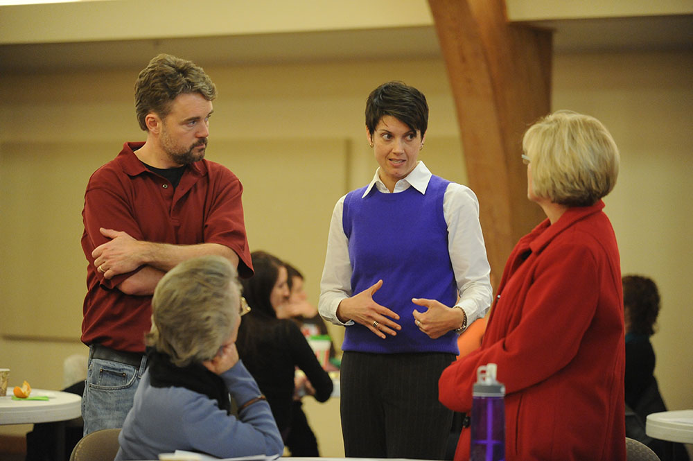 Maria Day, Spanish instructor; David LeVan, business instructor; and Tami Keim, education instructor, talk with Ashley Finley from the Association of American Colleges and Universities during a faculty in-service to kick off the spring 2012 semester.