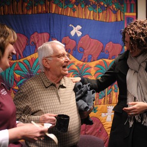 Bill Mason (center), longtime Hesston College employee, is congratulated by Melissa Unruh (left) and Rachel Swartzendruber Miller (right) during Mason’s retirement celebration at Hesston College Feb. 16.