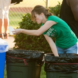 Hesston College sophomore Leah Mueller of Halstead, Kan., separates recyclables from trash during the college’s September 2011 homecoming celebration.