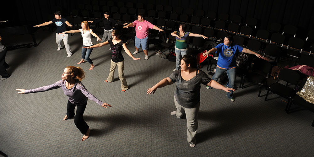 Hesston College Music Theatre Workshop students work with Danika Bielik (front), dance instructor at Bethel College Academy of Performing Arts (Newton, Kan.) on choreography for their upcoming performance.