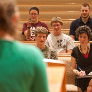 Michele Hershberger and preaching class students listen as a student practice preaches.