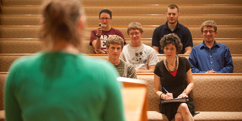 Michele Hershberger and preaching class students listen as a student practice preaches.