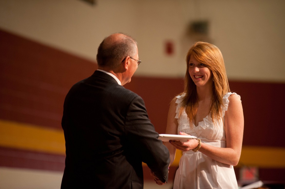 Kate Steury (New Paris, Ind.) receives her Hesston College diploma from President Howard Keim. Steury was one of 167 graduates of Hesston’s 102nd graduating class.