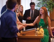 Air traffic control graduate Heather Harkins ’12(Wichita, Kan.) is congratulated by aviation department faculty and staff at a reception honoring aviation graduates in both flight and air traffic control.