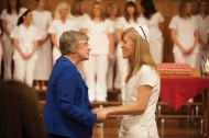 Erica Fitzmorris (Littleton, Colo.) receives a blessing of the hands from faculty member Sondra (Wedel) ’80 Leatherman during the 45th nursing pinning.