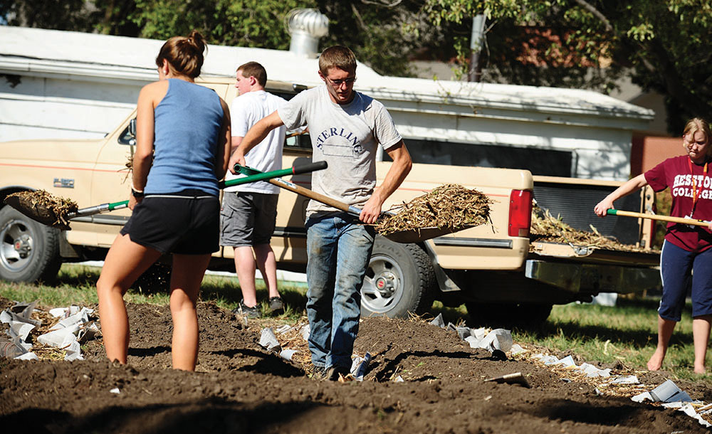 Jacob Landis works in the campus community garden. He brought methods and techniques he learned on the family farm for improved sustainability to campus.