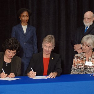 Dr. Sandra Zerger, Vice President of Academics at Hesston College, and Dean of the University of Kansas School of Nursing, Karen Miller, RN, Ph.D., FAAN, sign an articulation agreement for nurses.