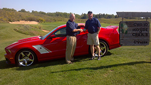 Tom West shakes hands with a Mel Hambleton Ford representative.