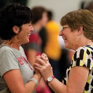 Sue (Eicher) ’73 Roth and Priscilla (Wyse) ’72 Clemens greet each other at the tailgate barbecue picnic and family festival Friday.