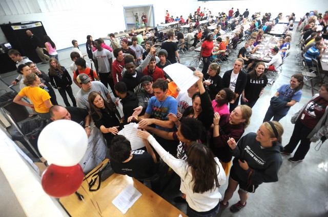 Hesston College students and prospective students scramble to pick up a clue sheet for the Homecoming Weekend scavenger hunt. The scavenger hunt sent the students to places around campus that will soon receive updates as part of a capital campaign, and also allowed them to learn about less familiar spots on campus. 