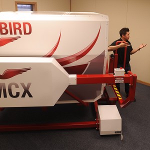 Hesston College Aviation program director Dan Miller (right) and flight instructor Travis Pickerill (center) get maintenance tips about the college’s new Redbird MCX C182 G1000 GFC700 flight simulator.