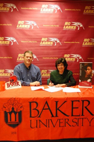 Mark Bandre, Baker University director of transfer services, and Dr. Sandra Zerger, Hesston College vice president of academics sign an articulation agreement for transfer students from Hesston to Baker on the Hesston College campus April 12.