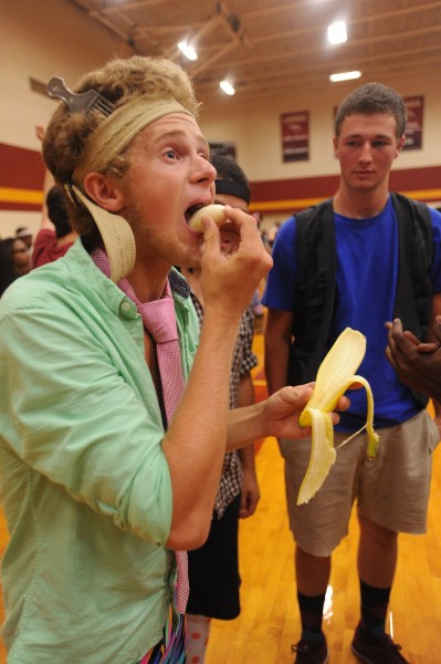 Freshman Jason Schroeder of Anthony, Kan., eats a banana as quickly as possible to end a relay race during Hesston College’s annual Mod Olympics Aug. 18 while freshman Jeshurun Shuman of Middletown, Pa., looks on.